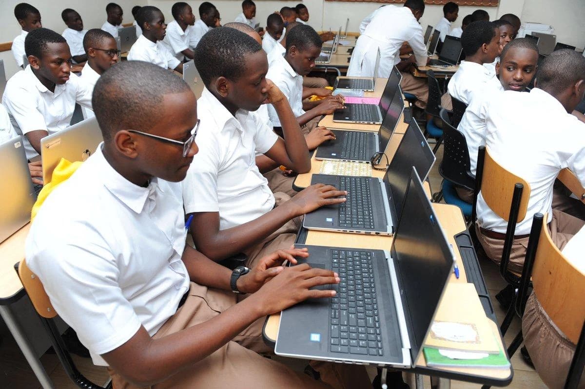 Students taking computer-based examinations at laptops in a school computer laboratory